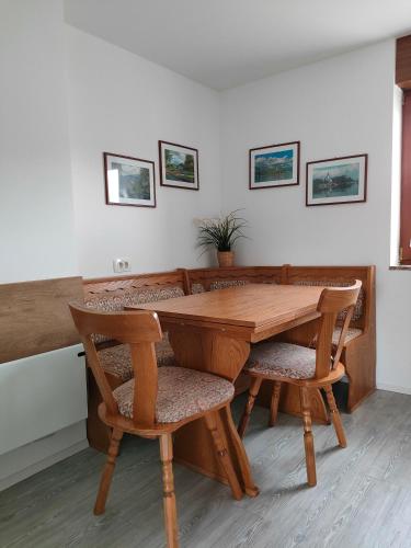 a wooden table and chairs in a room at Apartments & Rooms Aleksandra in Bled
