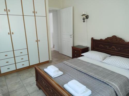 a bedroom with a bed with two towels on it at sparton amfilohias παραθαλάσσιο εξοχικό Filoxenia in Spárton