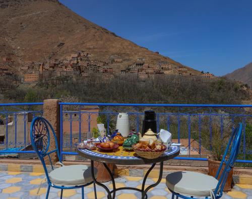 a table with a bowl of fruit on a balcony at Atlas Haven in Imlil