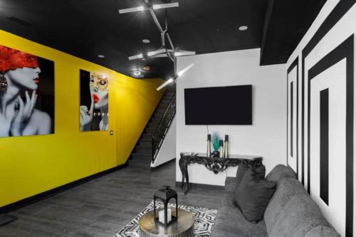 a living room with a couch and a yellow wall at The Black And White Suite in Chicago