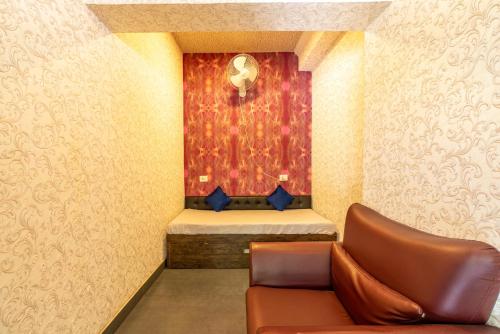 a waiting room with a couch and a bed at Seasons Suites JP Nagar in Bangalore