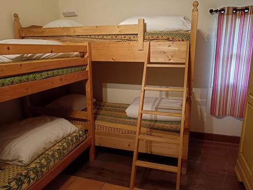 a bunk bed room with two bunk beds and a ladder at Mas de la Tour Carbonnière in Aigues-Mortes