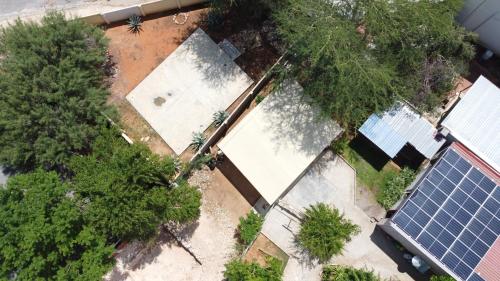 an overhead view of a house with a group of solar panels at Farmhouse Boutique Backyard Rooms in Outjo