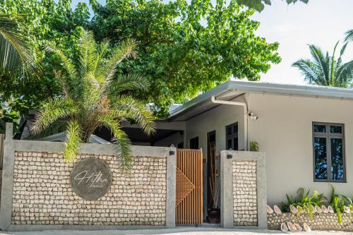 a house with a brick fence in front of it at Hitha Maldives in Omadhoo