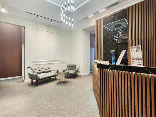 a waiting room with two chairs and a table at ELYSIUM HOTEL in Baku