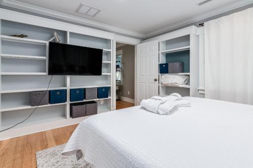 1 dormitorio blanco con 1 cama grande y TV de pantalla plana en Brotherly Love, en Southport