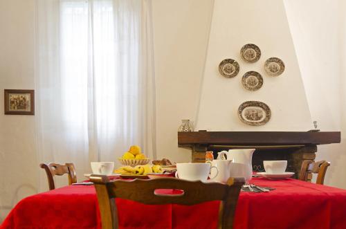 a dining room table with a red table cloth at Cà Morari in Argenta