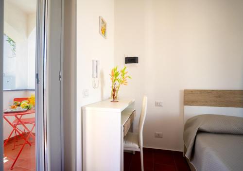 a bedroom with a desk and a bed and a table at Casa Mimi in Procida