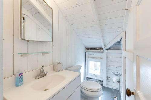 a white bathroom with a sink and a toilet at Charming Westbrook Cottage, Steps to Private Beach in Westbrook