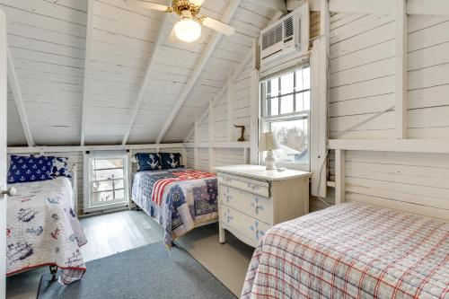 a bedroom with two beds and a window at Charming Westbrook Cottage, Steps to Private Beach in Westbrook