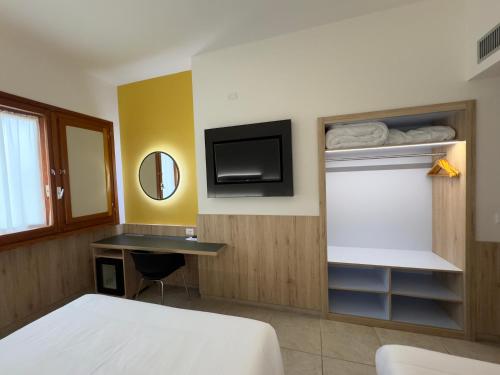 a hotel room with a bed and a tv at Hotel Holidays in Roccaraso