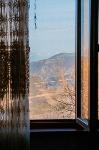 a window with a view of a mountain view at Rubina Bed and Breakfast in Tatʼev