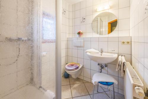 a bathroom with a sink and a toilet and a shower at Ferienwohnung Burghartswieser in Ruhpolding
