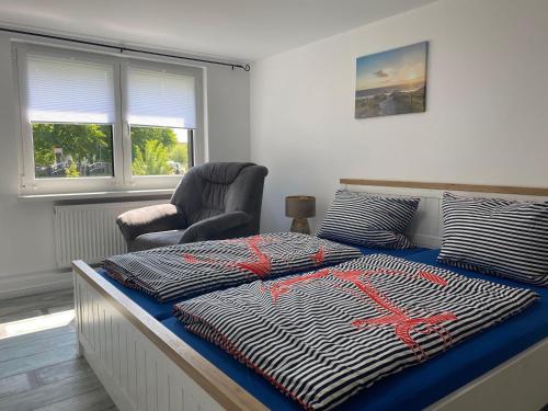 a bedroom with a bed with a red spider on it at Kuestenkind in Lobbe