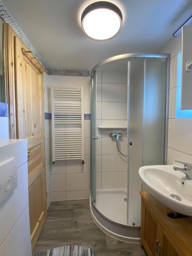 a bathroom with a shower and a sink at Kuestenkind in Lobbe