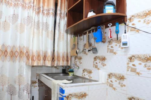 a kitchen with a sink and a counter top at Chaka Furnished Apartments in Kiganjo