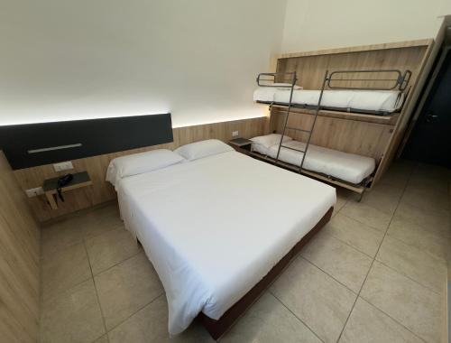 a bedroom with a bed and two bunk beds at Hotel Holidays in Roccaraso