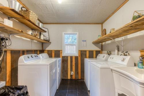 a laundry room with three washing machines and a sink at Mt Air Unit 4 · At the base of Mt Hood, family suite 4 in Mount Hood Village
