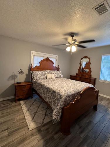 a bedroom with a bed and a ceiling fan at Cozy Ocean Springs Get-away in Ocean Springs