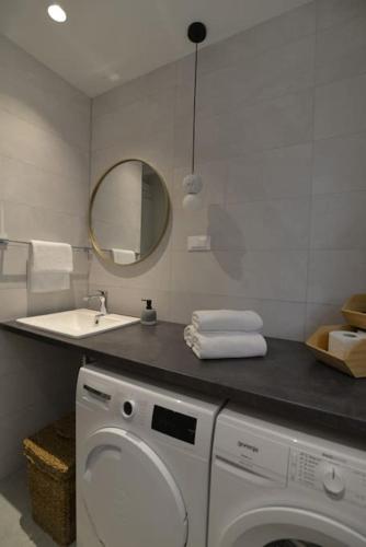 a bathroom with a washing machine and a sink at House Mvsevm 4* in Vis