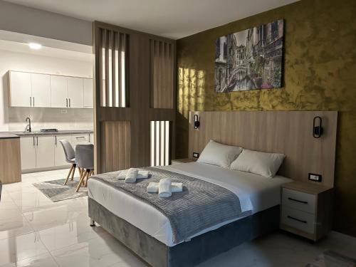 a bedroom with a large bed and a kitchen at WolfMoon in Herceg-Novi