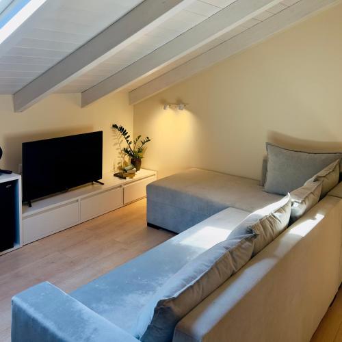 a living room with a couch and a flat screen tv at Rea Boutique Hotel in Himare