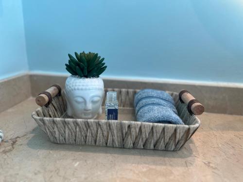 a bath tub with a statue of a head and towels at Luxury Morros Seaway Cartagena in Cartagena de Indias