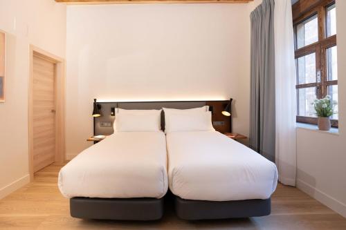 Voodi või voodid majutusasutuse Prisma Suites toas