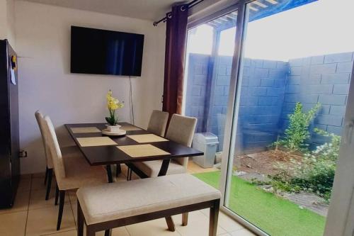a dining room with a table and chairs and a window at Modern Townhouse AC Wi-Fi full equipped Private in Santa Ana
