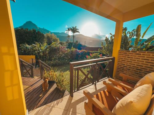 a view from a porch with a bird standing on the deck at Pousada Porto Girassol in Abraão