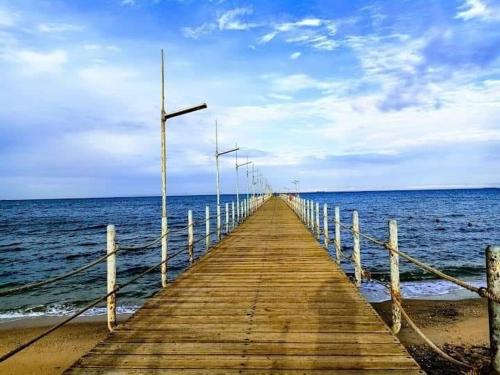 a wooden pier stretches out into the ocean at شاليه فندقي PORTO EL SOKHNA in Ain Sokhna
