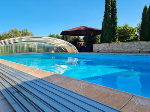 a swimming pool in front of a building at Penzión Pulse in Podhájska