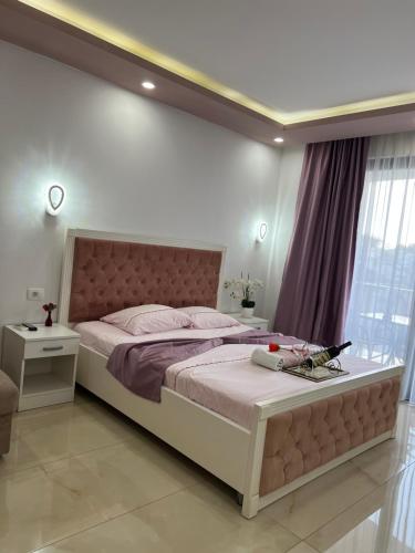 a bedroom with a large bed and a large window at City Heart Apartments in Ulcinj