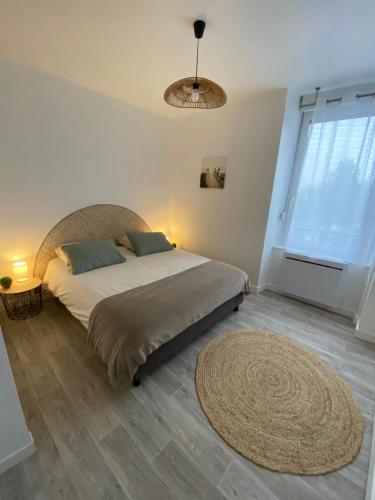 a bedroom with a bed and a large window at Taïcyté Beg Meil in Fouesnant