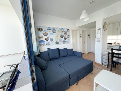 a living room with a blue couch in a room at Apartamento Vilem & Piscina, Wi-Fi in Costa Calma