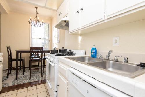 a kitchen with a sink and a table with chairs at One bedroom one bath apartment in Hollywood in Los Angeles