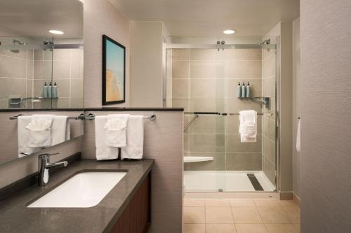 a bathroom with a sink and a shower at Courtyard by Marriott St. Petersburg Downtown in St. Petersburg