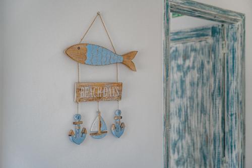 a wooden fish hanging on a wall next to a mirror at BALCÓN DEL ATLÁNTICO in Garachico