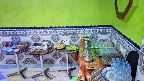a table with two stools with food on it at Auberge Cascade Imilchil in Imilchil