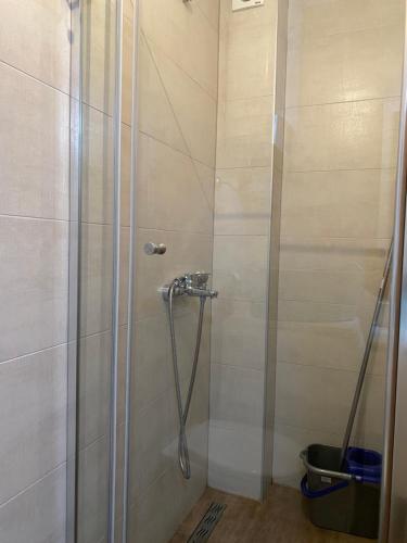 a shower with a glass door in a bathroom at Sunrise apartmani in Bar
