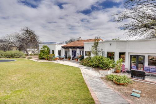 a house with a garden and a lawn at Beautiful Tucson Oasis with Pool, Views and Privacy! in Tucson