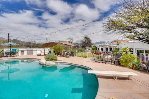 a swimming pool with a bench in a yard at Beautiful Tucson Oasis with Pool, Views and Privacy! in Tucson