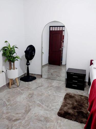 a room with a mirror and a red door at habitación cómoda en familia in Ibagué