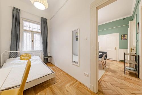 a bedroom with a bed and a living room at Downtown Rooms Wesselenyi in Budapest