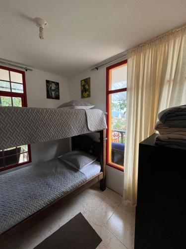 a bedroom with two bunk beds and a window at Villa Ocampo in Salento