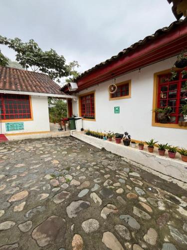 a house with a stone patio in front of it at Villa Ocampo in Salento