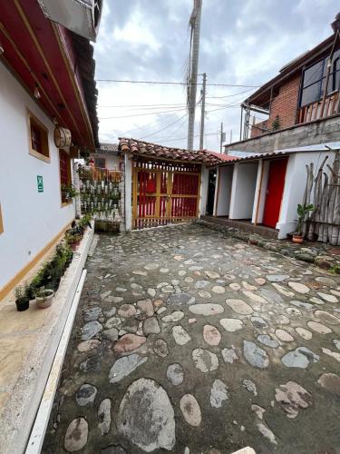 a courtyard of a house with a fence and rocks at Villa Ocampo in Salento