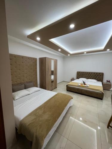 a bedroom with a large bed and a large ceiling at City Heart Apartments in Ulcinj