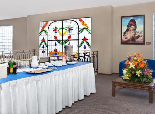 a conference room with a table and a stained glass window at Hotel Francia Aguascalientes in Aguascalientes