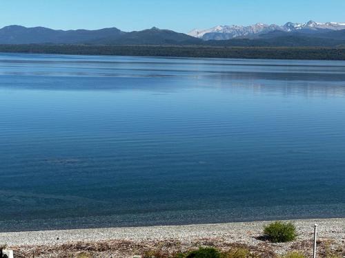 a large body of water with mountains in the background at Casa de las Chacras 2 in San Carlos de Bariloche